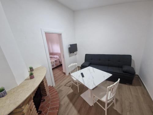 a living room with a couch and a table at Casa vacanze Grimaldi Paestum in Paestum