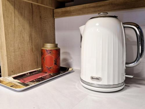 a tea kettle sitting on a counter next to a container at Birchington Vale - Luxury 3 bed, Pet friendly & Family Friend in Margate