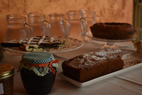 a table topped with two slices of cake and cakes at Agriturismo Col Morino in Pineto