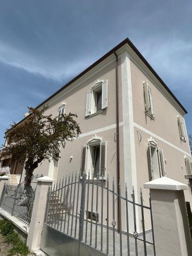 a building with a fence in front of it at Seaside - A Due Passi Dal Mare in Fano