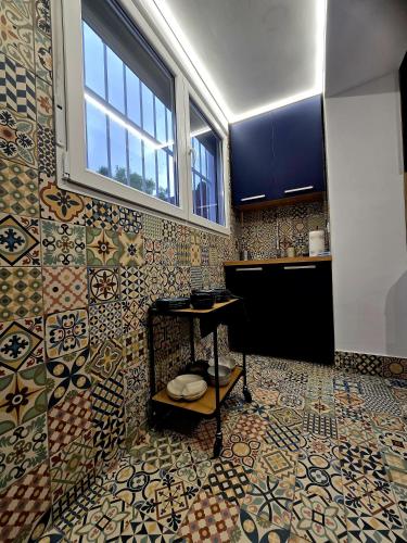 a kitchen with a sink and a tile wall at Casa Rural El Bressol in Barraca de Aguas Vivas