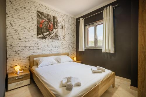 a bedroom with a bed with towels on it at VillaTota in Umag