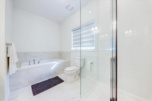 a bathroom with a shower and a toilet and a tub at Detached New Modern House In South Barrie - Built H plus ME Technology in Barrie