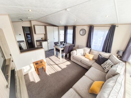 a living room with a couch and a table at Birchington Vale - 2 Bedroom Holiday Home in Margate