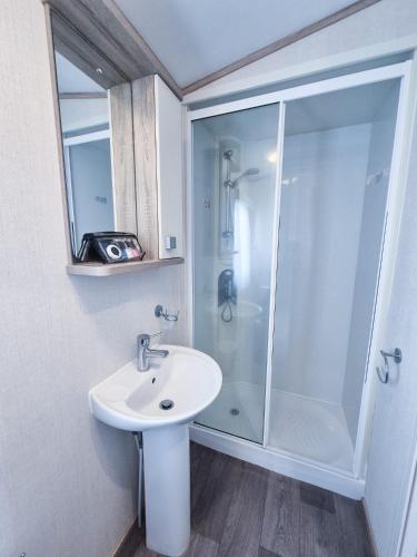 a bathroom with a shower and a sink at Birchington Vale - 2 Bedroom Holiday Home in Margate