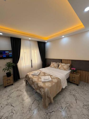 a bedroom with a large bed with two towels on it at Hotel By Historia in Istanbul