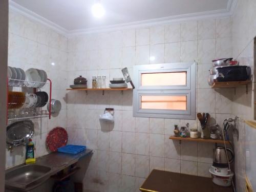 a small kitchen with a sink and a window at Gadou Rooms -Private & Shared Stays in Port Said Best Location in Port Said