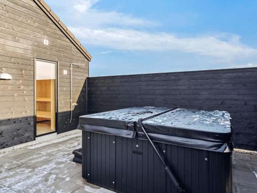 a mattress sitting on top of a black fence at 5 star holiday home in Nørre Nebel in Nørre Nebel