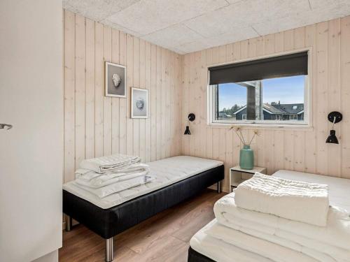 a bedroom with two beds and a window at 5 star holiday home in Nørre Nebel in Nørre Nebel