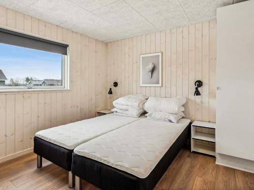 a large bed in a room with a window at 5 star holiday home in Nørre Nebel in Nørre Nebel