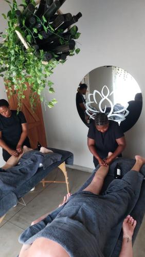 a man getting a massage in a room at The Baobab Bush Lodge and Villa in Hoedspruit