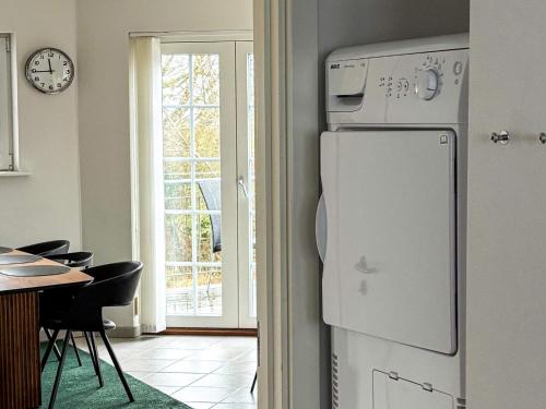 a kitchen with a refrigerator and a table and a window at 8 person holiday home in Bogense-By Traum in Bogense