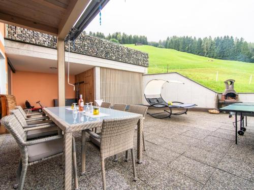 a patio with a table and chairs and a grill at Sonnenwinkel I in Kolsassberg