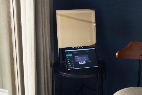 a laptop computer sitting on a stool in a room at BbyC Hotel 那覇 レンタカー付ホテル in Naha