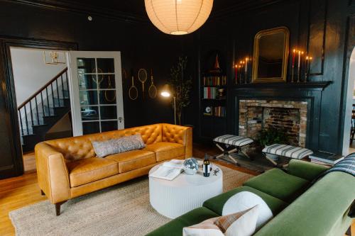 a living room with a couch and a fireplace at The Ipswich Inn in Ipswich