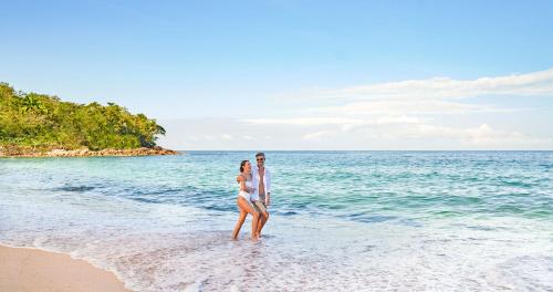 a man and a woman walking on the beach at Grand Park Royal Puerto Vallarta - All Inclusive in Puerto Vallarta