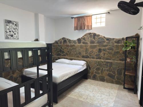 a room with two bunk beds and a window at Casa Encanto in Taganga