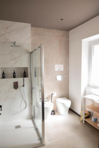 a bathroom with a shower and a toilet and a sink at LN 5 Gate-Corso Italia in Catania