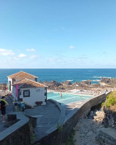 a resort with a swimming pool and a beach at Olhinhos de Azeitona - Quatro Ribeiras in Praia da Vitória