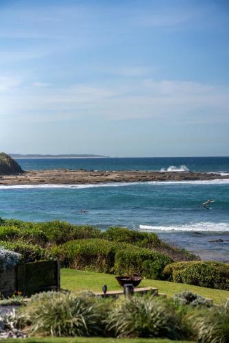 a view of the ocean from a park at Absolute Beachfront l Couples Getaway in Blue Bay 