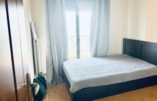 a bed in a room with a window at Κατοικια Α Οροφου in Arkítsa