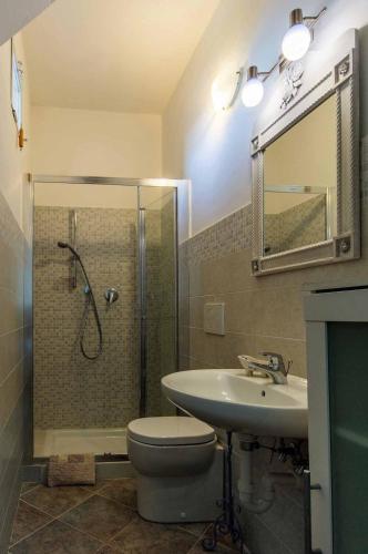 a bathroom with a shower and a toilet and a sink at Villa Pierina in Finale Ligure