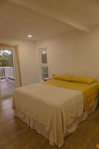 a bedroom with a bed in a room at Papaya Republic in Utila