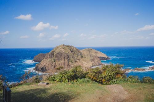 a large rock in the middle of the ocean at 【佐渡/一棟貸切】オーシャンビュー古民家SeaSideStory椿 離れ in Sado