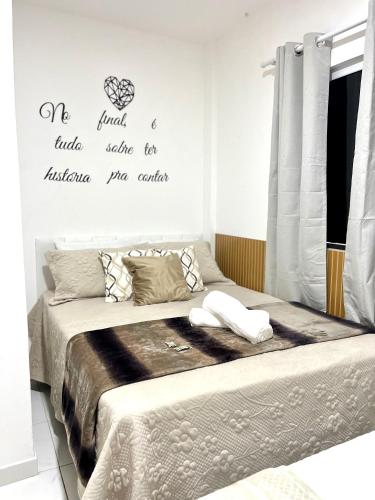 a bedroom with two beds and words on the wall at Maré Praiana Rede de Hospedagens in Lauro de Freitas