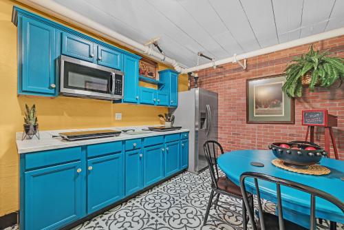 a kitchen with blue cabinets and a blue table at The Extraordinary Camino Hotel in Camino