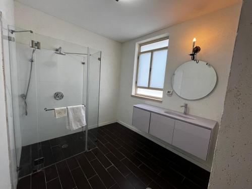 a bathroom with a shower and a sink and a mirror at Five Stars Villa09 in Hod HaSharon