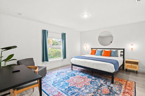a bedroom with a bed and a table and a desk at Bright & Spacious 3BR Close to Beaches in West Palm Beach