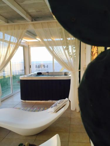 a large bathroom with a tub and a toilet at SUITEBEACH b&b and resort in Marsala