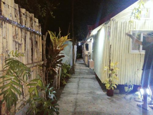 a narrow alley with a building and plants on the side at JUNGLE GYM LA UNION Prana fan kubo 2 pax in Rimus