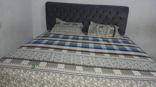 a bed with a blanket and pillows on it at Spring Hotel in Belém