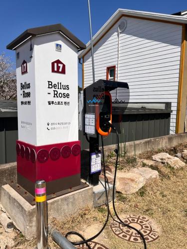 a gas pump in front of a house at Bellus-Rose Pension Gyeongju in Gyeongju