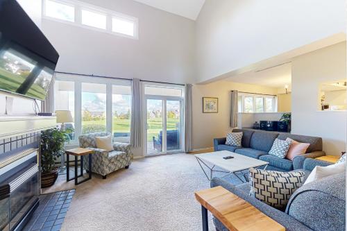 a living room with a couch and a tv at Wintergreen 122 in Blue Mountains