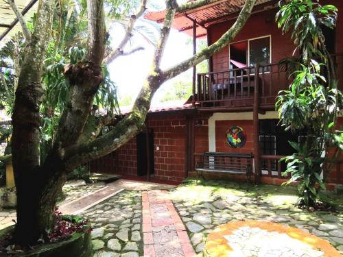 a house with a tree in front of it at El susurro del agua exclusiva - natural in Ibagué