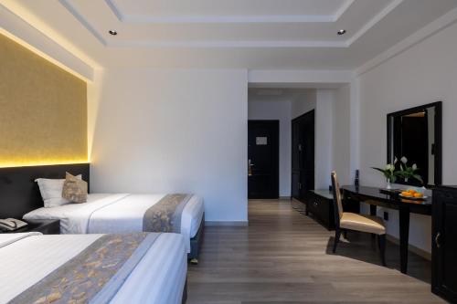Postel nebo postele na pokoji v ubytování Rosaleen Boutique Hotel