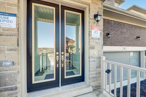 a home with a glass door with a balcony at Detached New Modern House In South Barrie - Built H plus ME Technology in Barrie