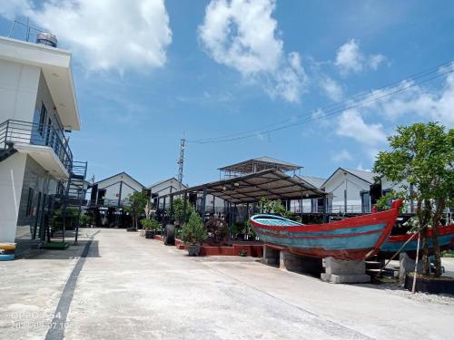 two boats on display in front of a building at Mobile Home Ho Tram Pristine Beach in Thuận Biên