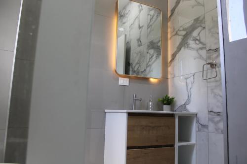 a bathroom with a sink and a mirror at Apartment in the heart of SA in Santa Ana
