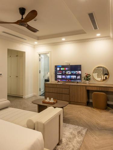 a living room with a couch and a flat screen tv at Family Villa - Phu Quoc Island in Phu Quoc