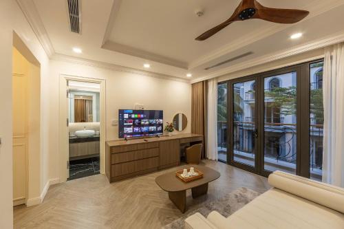 a living room with a couch and a tv at Family Villa - Phu Quoc Island in Phu Quoc