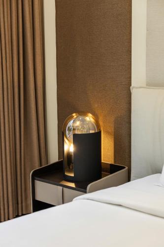 a room with a bed and a candle on a night stand at Family Villa - Phu Quoc Island in Phu Quoc