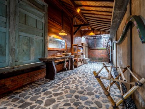 a room with wooden walls and a table in a building at Aruna Jayanti Villa in Tejakula