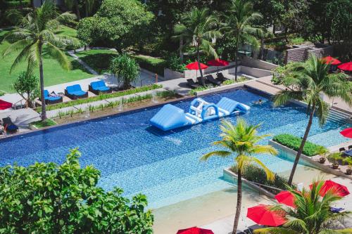 an overhead view of a swimming pool with umbrellas at Amari Hua Hin in Hua Hin