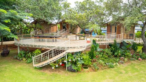 a tree house with a deck and a garden at Greenfield Farmstay Vung Tau in Ba Ria