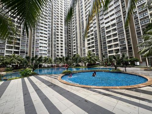 a large swimming pool in front of tall buildings at Pool View 3 Bedroom & 3 Bathroom Whole Unit in Johor Bahru
