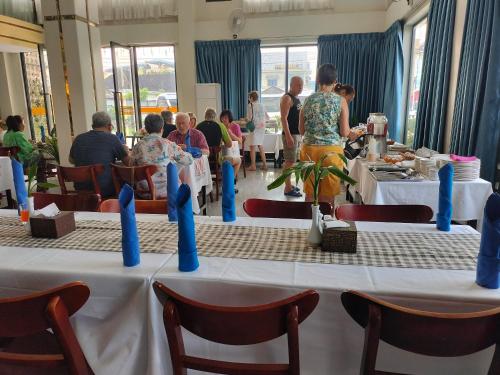 a group of people sitting at tables in a restaurant at Kampot Sunny Hotel in Kampot